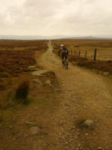 Brian descending from Stanage Pole under the red sky due to blown Saharan sand.